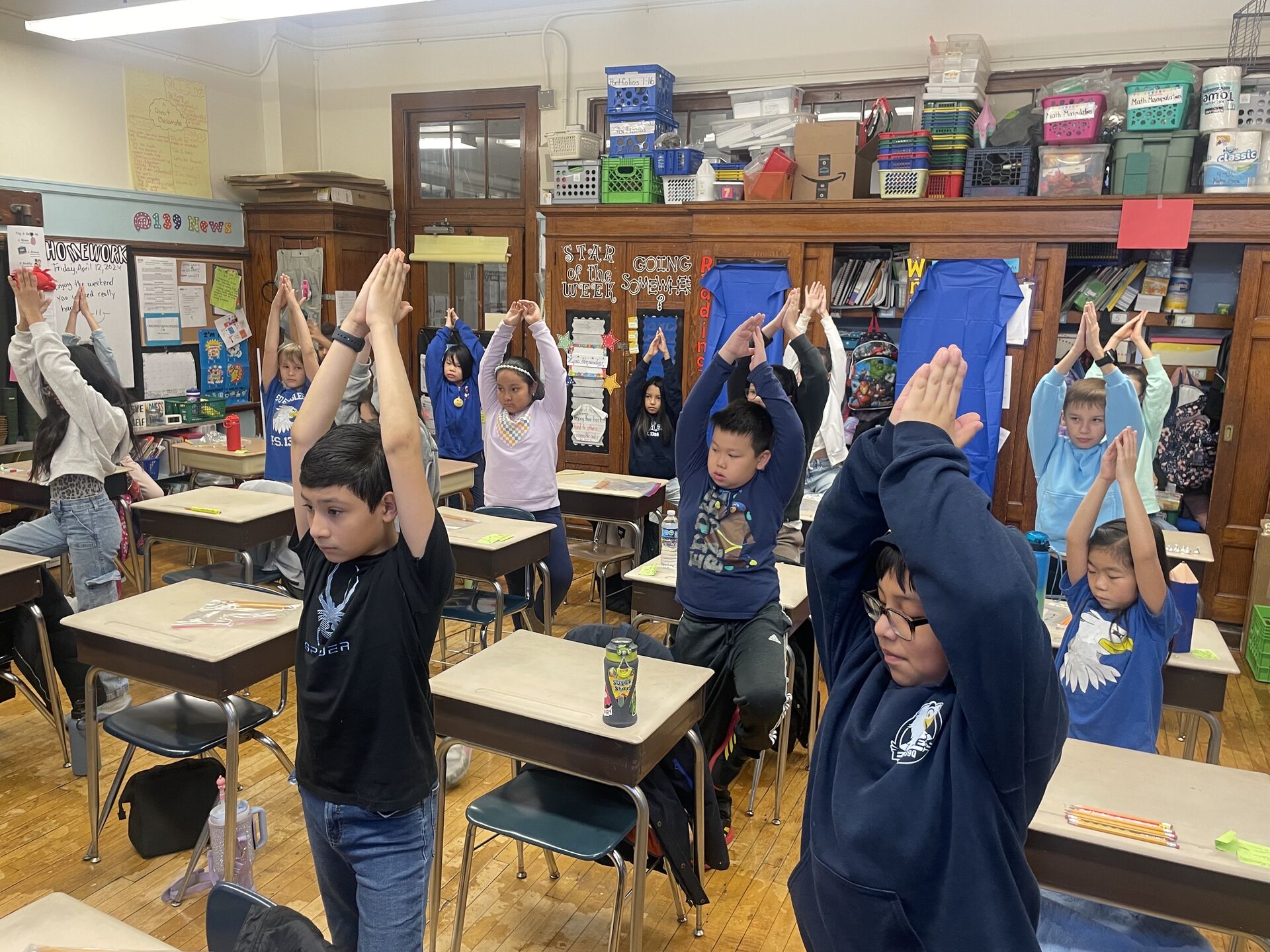 Students stretching and doing yoga in the classroom